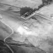 Oblique aerial view centred on the remains of the settlement, taken from the WNW.