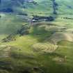 Oblique aerial view centred on the remains of the fort and linear earthwork with the remains of the linear earthwork and pit-alignment adjacent, taken from the E.