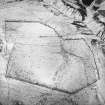 Oblique aerial view centred on the remains of the farmstead, rig, enclosures and quarry with sheepfolds adjacent, taken from the SW.