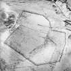 Oblique aerial view centred on the remains of the farmstead, rig, enclosures and quarry with sheepfolds adjacent, taken from the SSW.