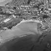 Oblique aerial view of Kinghorn centred on the harbour, taken from the SW.