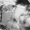 Thornybank, oblique aerial view, taken from the ESE, centred on cropmarks and a ring-ditch. A possible settlement is visible in the top left-hand corner of the photograph.