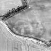 Oblique aerial view centred on the soilmarks of the settlement, taken from the NW.