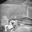 Oblique aerial view centred on the cropmarks of the enclosures, taken from the NE.