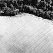 Carrington Barns, enclosure and cropmarks: oblique aerial view, taken from the NNW, centred on the cropmarks of an enclosure.