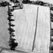 Woodhead, oblique aerial view, taken from the SE, centred on the cropmarks of the N corner of a Roman enclosure.