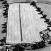 Woodhead, oblique aerial view, taken from the NW, centred on the cropmarks of the N corner of a Roman enclosure.