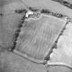 Oblique aerial view centred on the cropmarks of the Roman enclosure, taken from the ESE.