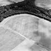 Oblique aerial view centred on the cropmarks of the pit-alignment, palisaded settlement, ring-ditches and enclosures, taken from the WNW.