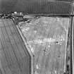 Westfield, Inveresk, oblique aerial view, taken from the WSW, centred on the cropmarks of ditches of the W side of the cursus monument, crossed by the cropmark of a dismantled mineral railway.