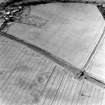 Brunstane, oblique aerial view, taken from the NE, centred on cropmarks, possibly of coal pits. The cropmarks of an enclosure are shown in the top right-hand corner of the photograph.