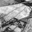 Westfield, Inveresk, oblique aerial view, taken from the N, showing the cropmarks of a cursus monument in the left half of the photograph. The cursus is bisected by the cropmark of a dismantled mineral railway.