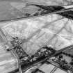 Westfield, Inveresk, oblique aerial view, taken from the N, centred on the cropmarks of a cursus monument. The cursus is bisected by the cropmark of a dismantled mineral railway.