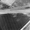 Oblique aerial view centred on the cropmarks of the ring-ditch, pits and rig, taken from the S.