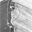 West Mains, oblique aerial view, taken from the W, centred on the cropmarks of the S half of a fort.