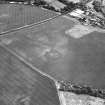 Brunstane, oblique aerial view, taken from the W, centred on the cropmarks of an enclosure, coal pits and shaft, a possible enclosure and rig.  Other cropmarks are also visible.