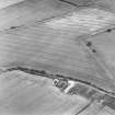 Oblique aerial photograph centred on the cropmark of a fort, taken from the SSE.