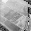 Oblique aerial view centred on the cropmarks of the palisaded enclosure, cropmarks, cultivation remains and possible ring-ditches, taken from the WNW.