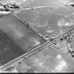 South Lodge and Prestongrange Crossing, oblique aerial view, taken from the N, centred on cropmarks including those of enclosures and pits.