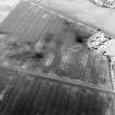 Oblique aerial view centred on the cropmarks of the coal-pits, field-boundary, settlement and further cropmarks, taken from the S.