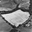 Middlestead, oblique aerial view, taken from the WSW, centred on the cropmarks of an enclosure. The settlement at Mote Linn is also visible in the centre right of the photograph.