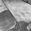 Cortleferry, oblique aerial view, taken from the SW, centred on the cropmarks of a palisaded enclosure and settlement.