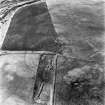 Headshaw, oblique aerial view, taken from the ENE, centred on the cropmarks of a fort.