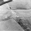 Oblique aerial view of Headshaw centred on the cropmarks of a fort, taken from the W.