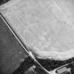 Oblique aerial view centred on the cropmarks of the henge, taken from the E.