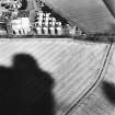 Wester Pencaitland, oblique aerial view, taken from the SSW, centred on the cropmarks of a fort. Pencaitland Maltings is visible in the top left-hand corner of the photograph.