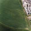 Oblique aerial view centred on the cropmarks of the fort with maltings adjacent, taken from the ESE.