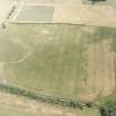 Oblique aerial photograph of Fala Dam, taken from the SW, centred on the cropmarks of a Roman temporary camp.