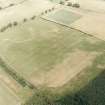 Oblique aerial photograph of Fala Dam, taken from the SSW, centred on the cropmarks of a Roman temporary camp.