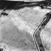 Saltoun Home Farm, oblique aerial view, taken from the WNW, centred on the cropmarks of an enclosure and a pit-alignment.