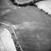 Saultoun Home Farm, oblique aerial view taken from the SE, centred on the cropmarks of an enclosure and pit-alignments.