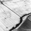 Oblique aerial view centred on the cropmarks of the ring-ditch and possible enclosure, taken from the W.