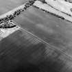 Oblique aerial view centred on the cropmarks of the palisaded enclosure and rig and the cropmarks of the ring-ditch and possible unenclosed settlement, taken from the ESE.