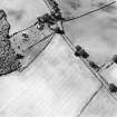 Oblique aerial view centred the cropmarks of the field boundary with church, burial ground and burial enclosure adjacent, taken from the E.