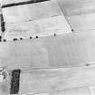 Oblique aerial view of Huntshaw centred on the cropmarks of a settlement and enclosures, taken from the SSE.