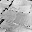 Oblique aerial view of Huntshaw centred on the cropmarks of a settlement and enclosures, taken from the SE.