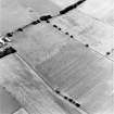 Oblique aerial view of Huntshaw centred on the cropmarks of a settlement and enclosures, taken from the ESE.