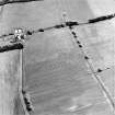 Oblique aerial view of Huntshaw centred on the cropmarks of a settlement and enclosures, taken from the E.