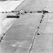 Oblique aerial view of Huntshaw centred on the cropmarks of a settlement and enclosures, taken from the ENE.