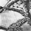 Ravenswood, oblique aerial view, taken from the ESE, centred on a linear cropmark. The site of a Roman Temporary Camp and Ravenswood country house and walled garden are visible in the top half of the photograph.