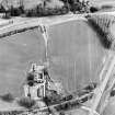 Oblique aerial view centred on the cropmarks of the SE of a Roman temporary camp with the western ditch and corner of Ravenswood temporary camp and linear cropmarks adjacent, taken from the W.