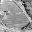 Oblique aerial view centred on the cropmarks of the SE of a Roman temporary camp with the western ditch and corner of Ravenswood temporary camp and linear cropmarks adjacent, taken from the S.