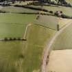 Oblique aerial view centred on the cropmarks of the eastern and southern annexes of the Roman Fort, taken from the W.