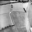 Oblique aerial view centred on the cropmarks of the eastern and southern annexes of the Roman Fort, taken from the W.