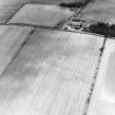Oblique aerial view of Huntington centred on the cropmarks of a settlement and barrow, taken from the SW.