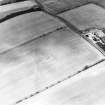 Oblique aerial view of Huntington centred on the cropmarks of a settlement and barrow, taken from the SSW.